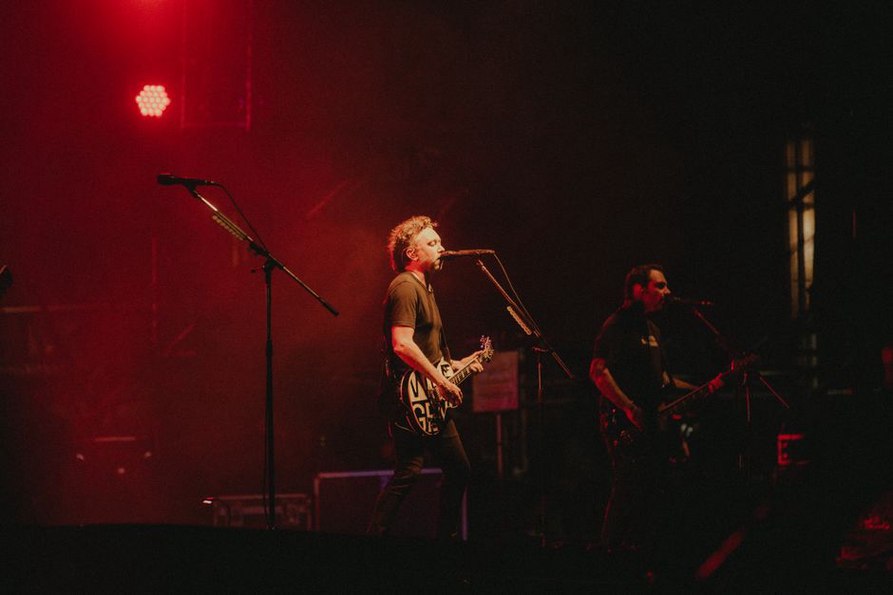 Band performing with intense lighting effects