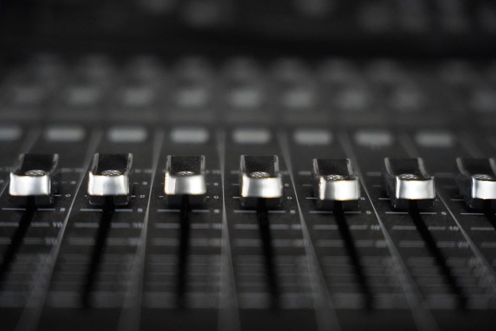 A mixer balancing a heavy guitar recording