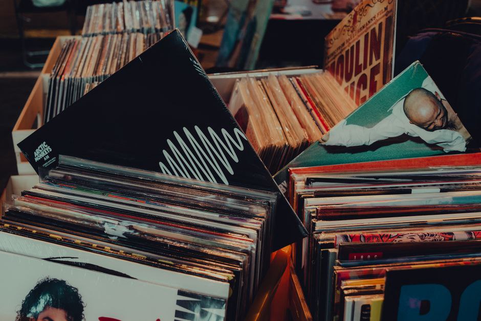 Records and shirts laid out beside a festival stage