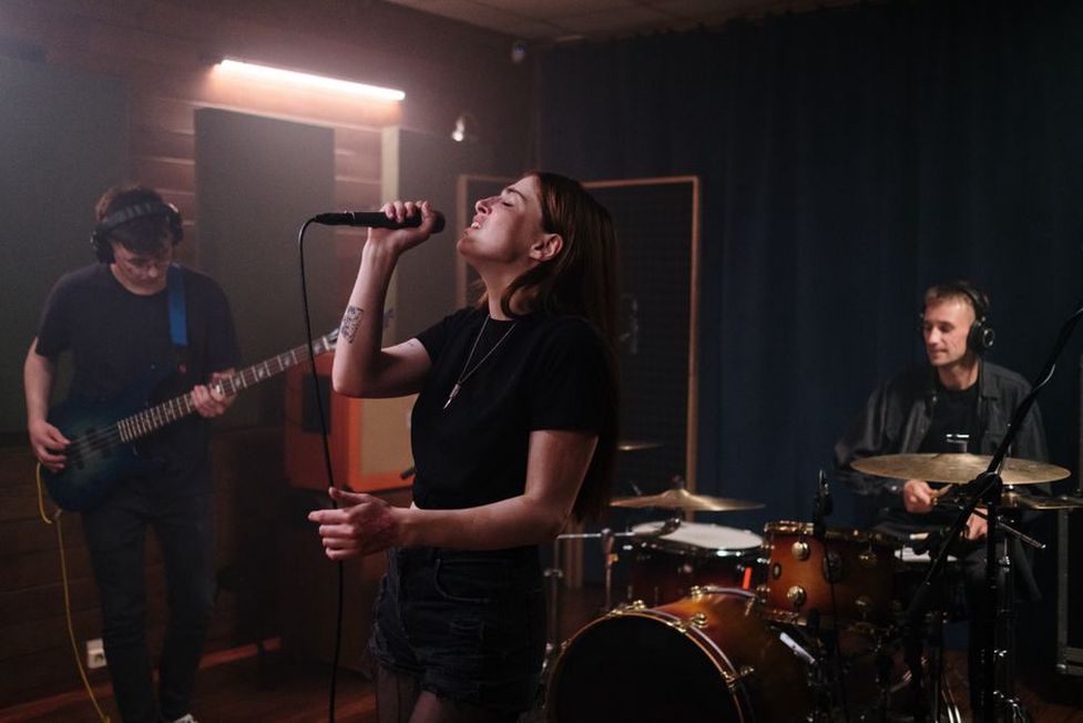 Singer at a microphone during a vocal take
