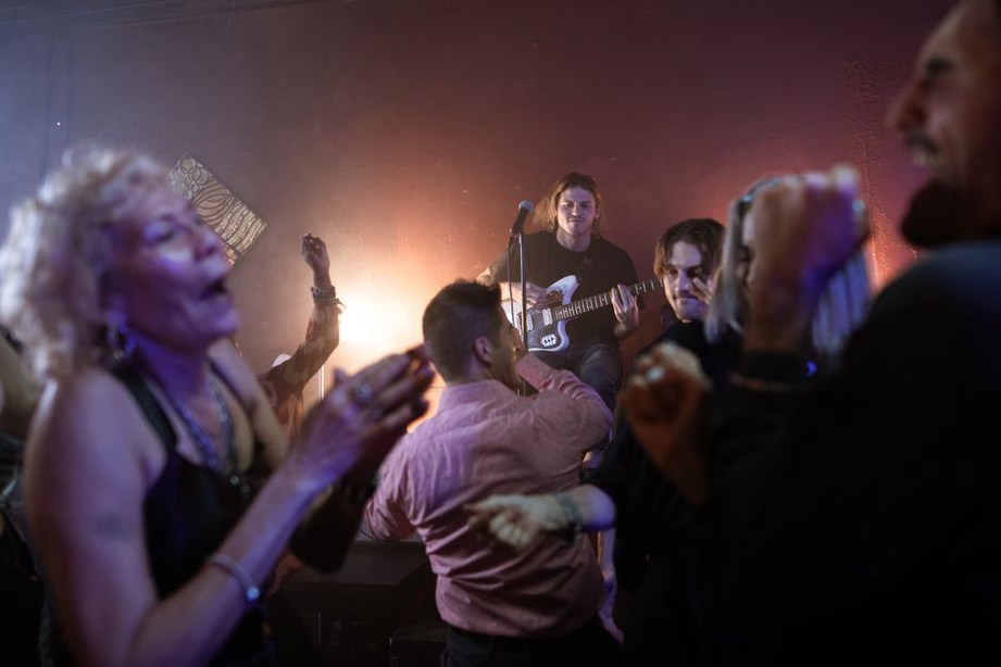 Guitarist playing close to a crowded club floor