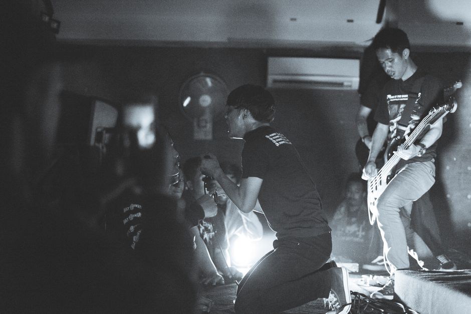 Guitar amps facing a close-packed club audience