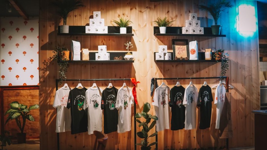Records and shirts laid out beside a club stage