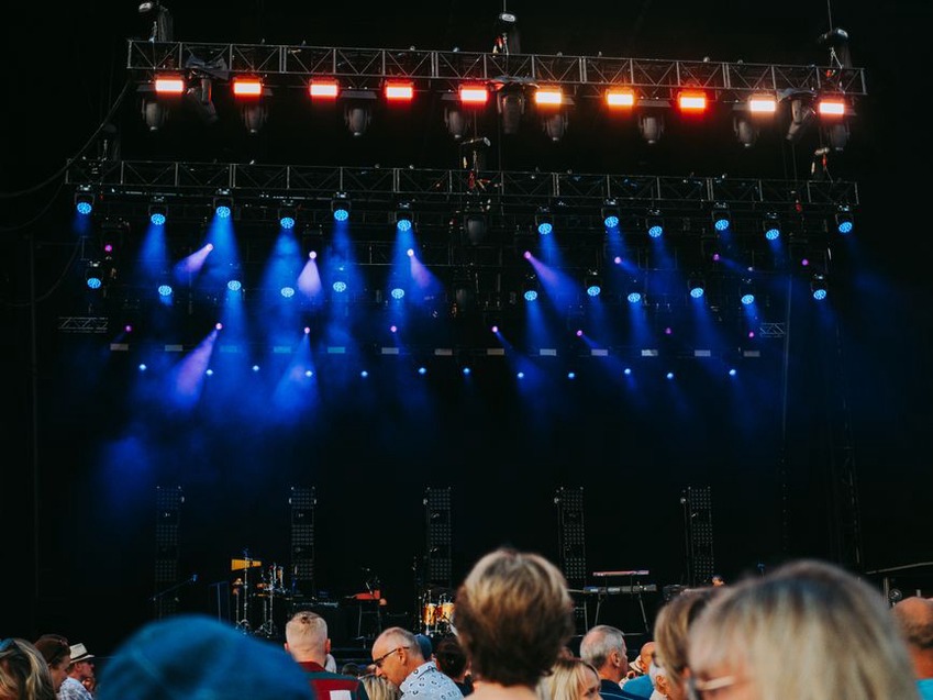 Audience gathered close to a low stage