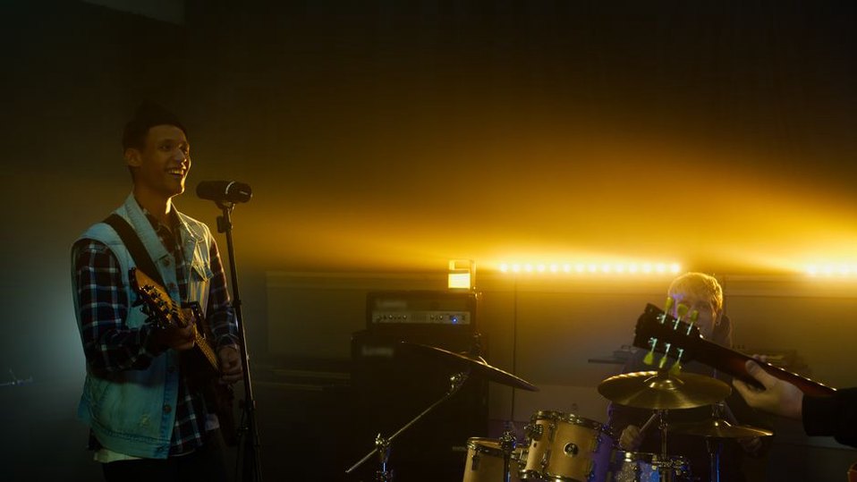 Drummer and guitarist locking into rapid accents