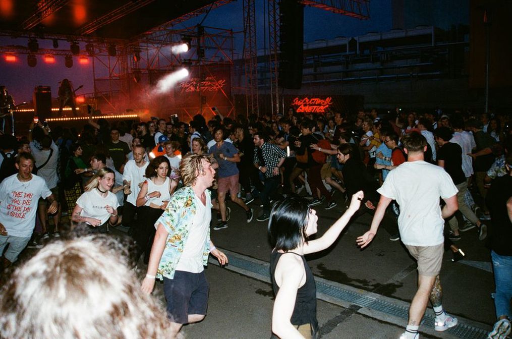 A compact club crowd moving beneath stage lights