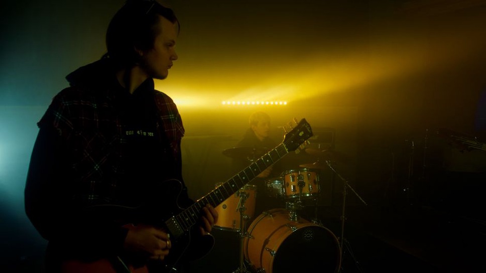 Musicians perform close to a club audience