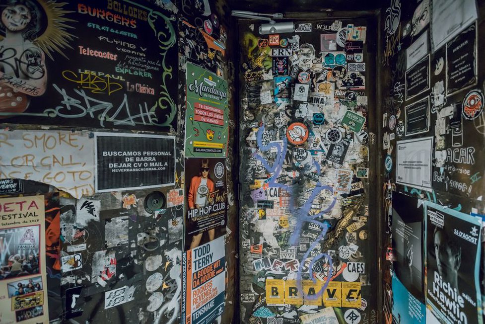 Gig flyers beside records from a local metal scene