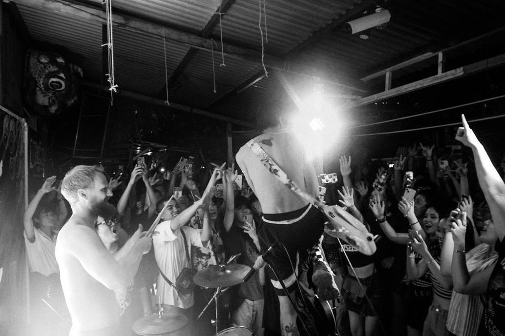 Fans gather close to a compact stage