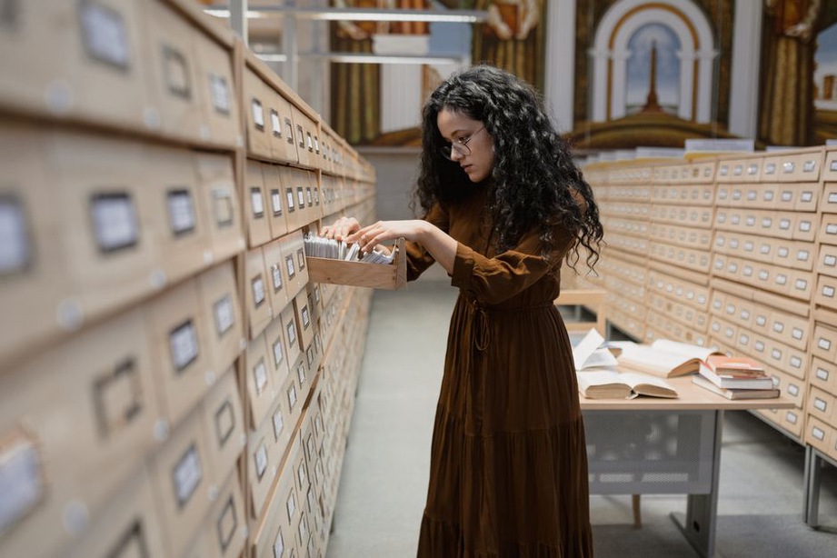 Record details checked against notes at a desk