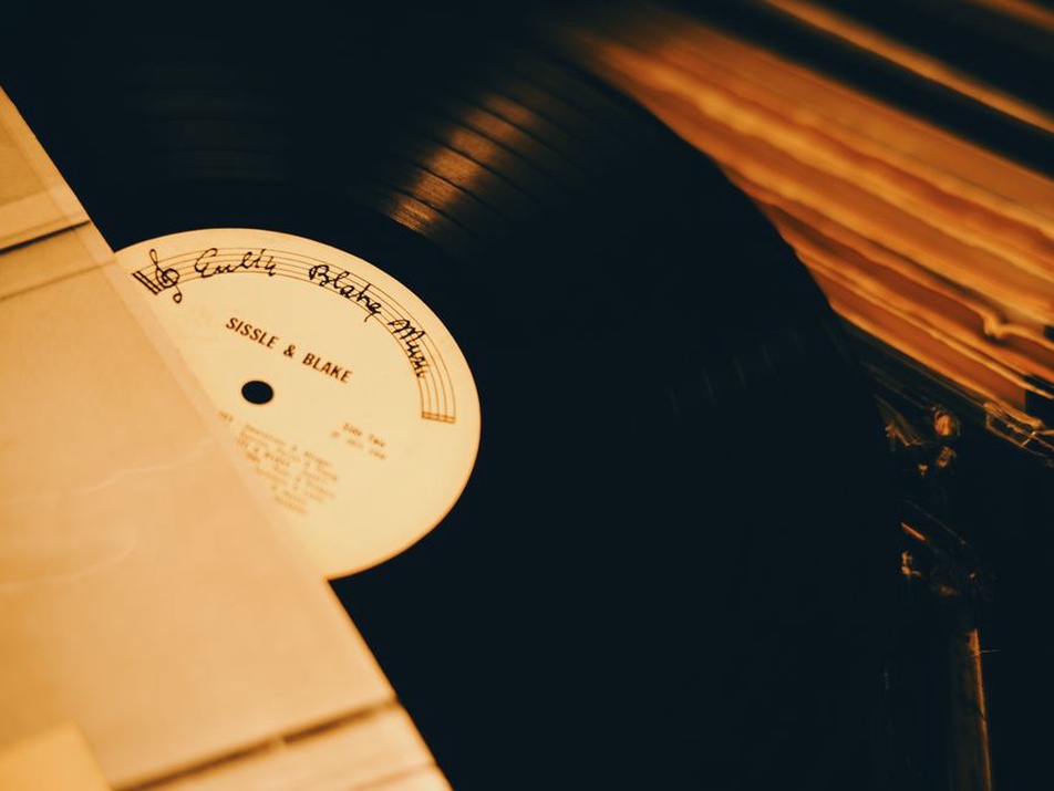 Handwritten label on a record sleeve beside notes