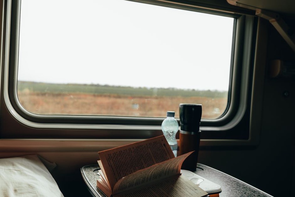 Quiet essentials laid out beside a carriage window