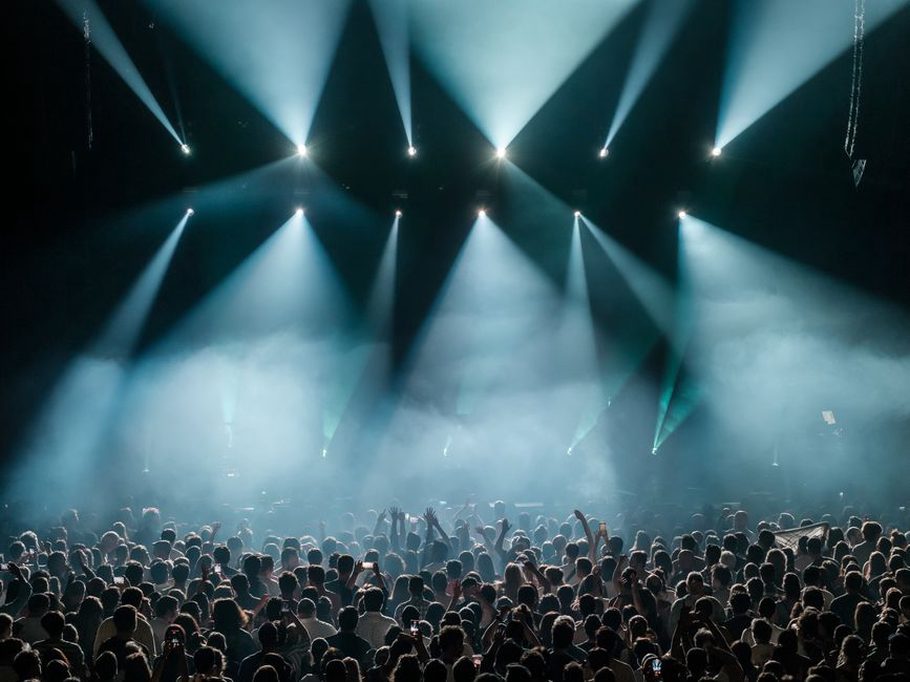 A tightly packed crowd facing a metal stage