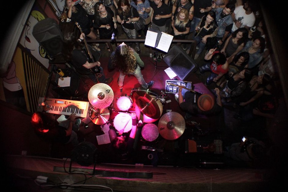 A compact crowd facing a loud club stage