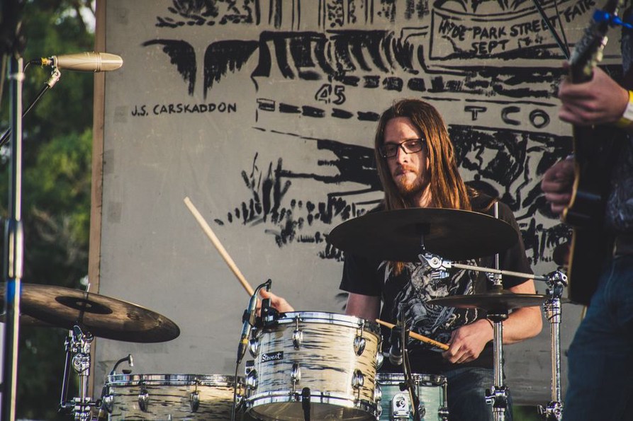 Thrash musicians play beneath festival stage lights