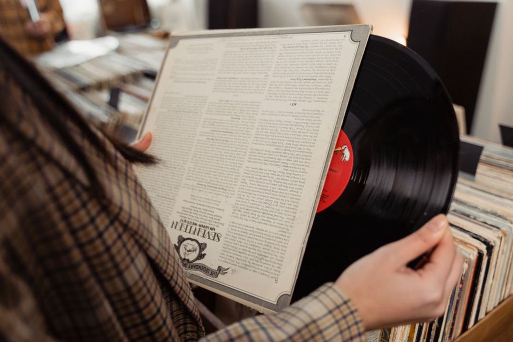 A collector checks a record sleeve before buying