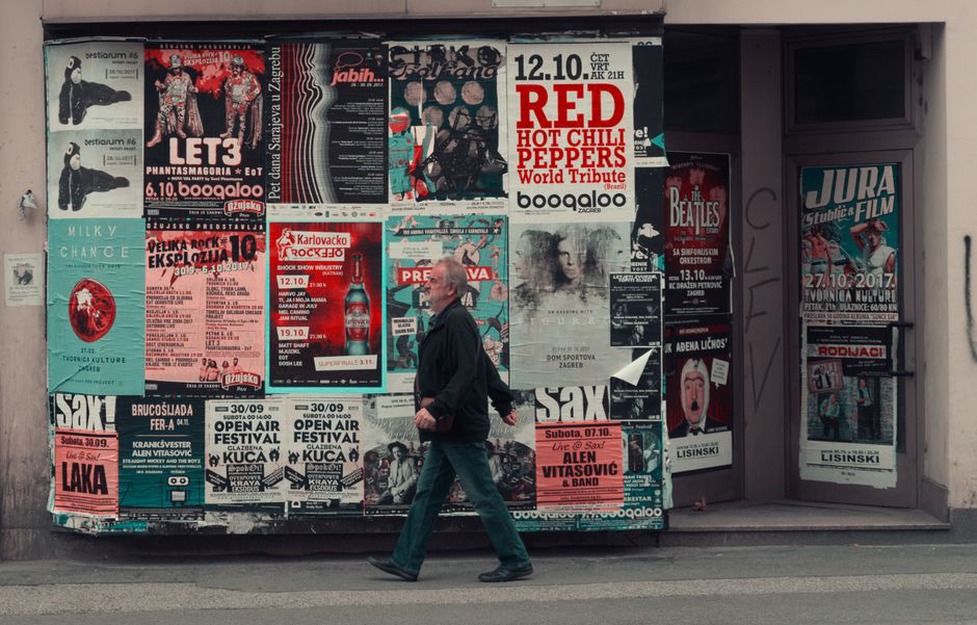 Gig posters beside folded shirts at a metal show